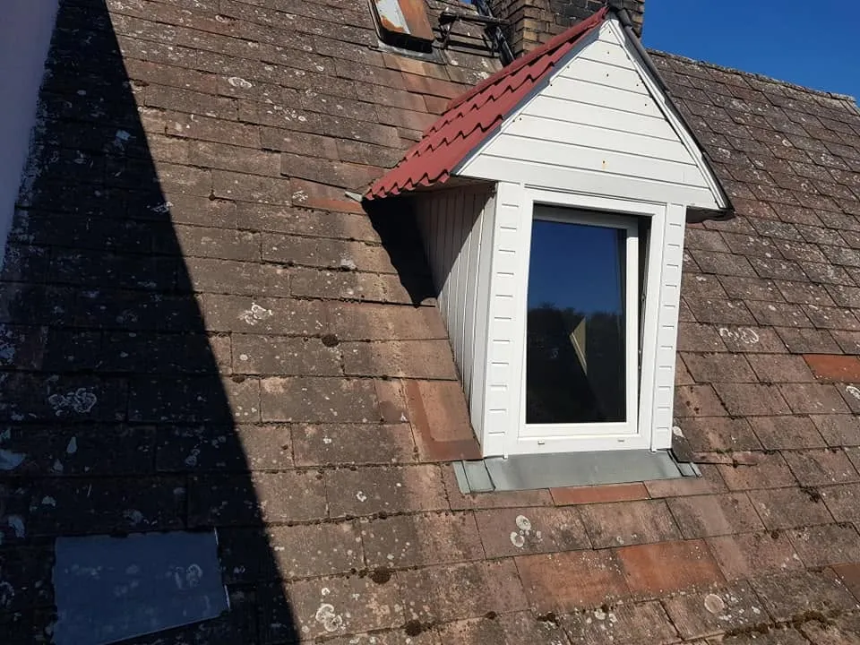 Lukarna z obróbką blacharską na starym dachu z dachówki ceramicznej